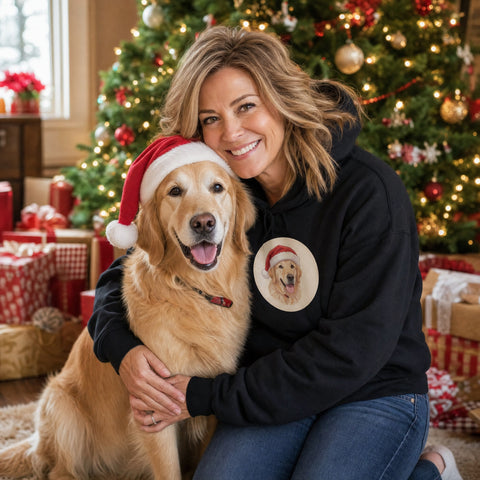 AI-generated example photo: woman hugging her golden retriever by the Christmas tree, wearing the custom pet portrait hoodie with a Santa-hat portrait