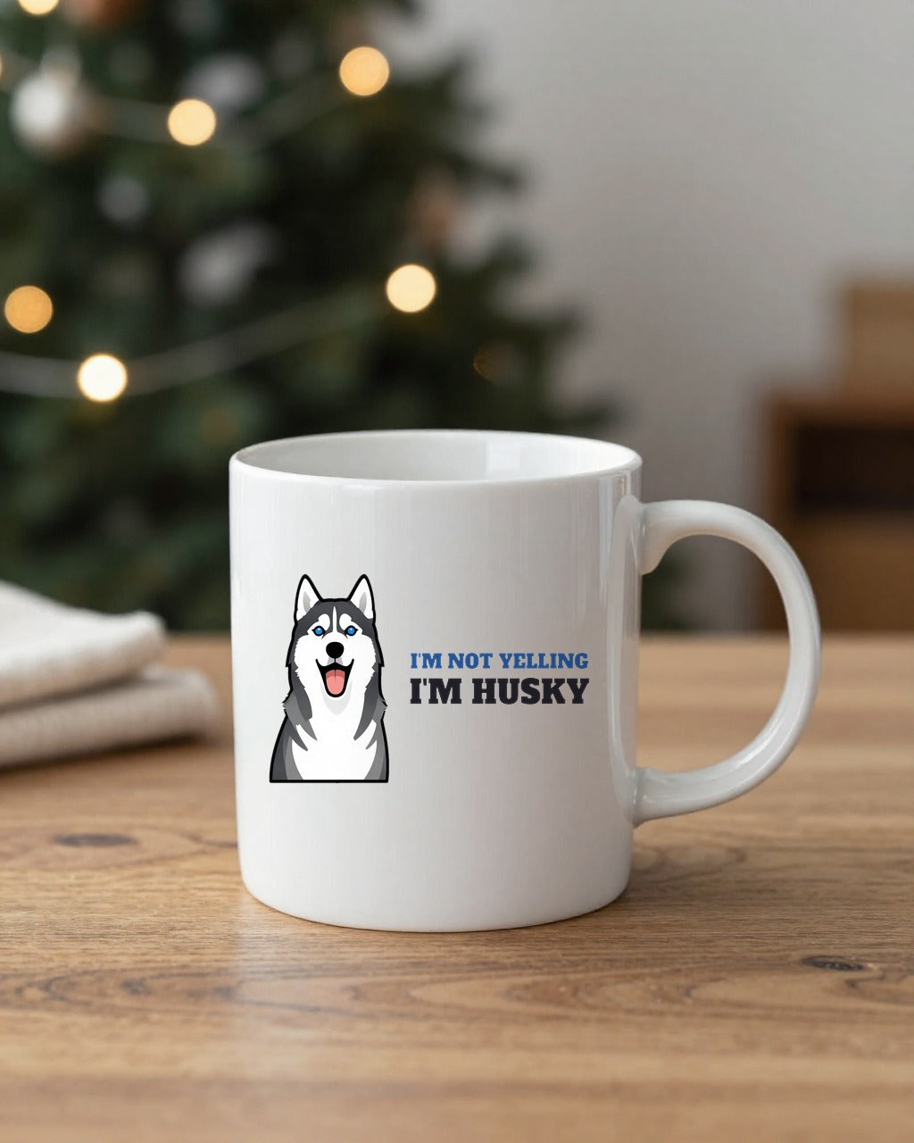 Not Yelling Husky mug on a table by a Christmas tree