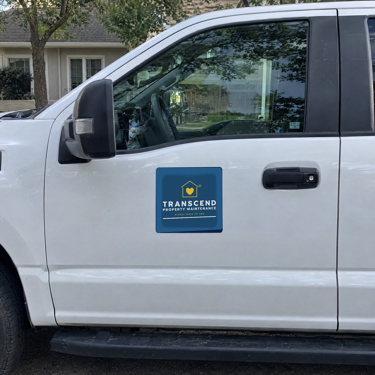 Transcend Property Maintenance car magnet on a white work truck door (AI-generated example scene, artwork placed from the real design)