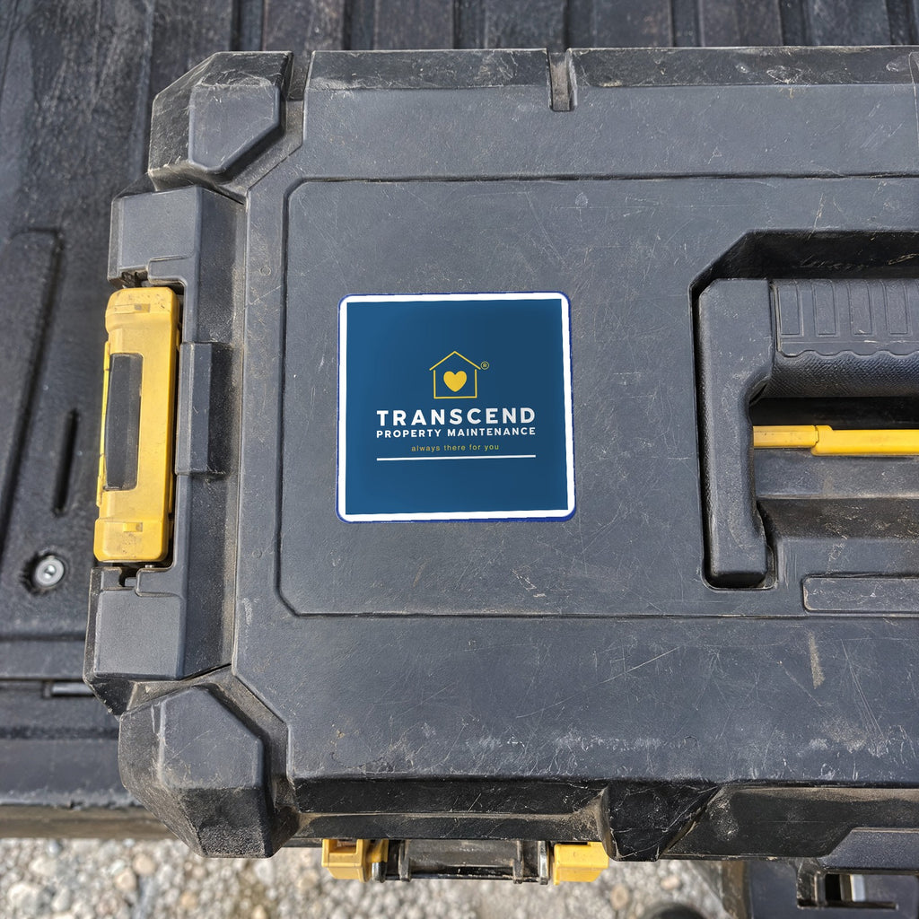 Transcend Property Maintenance logo sticker on a job-site tool box (AI-generated example scene, artwork placed from the real design)