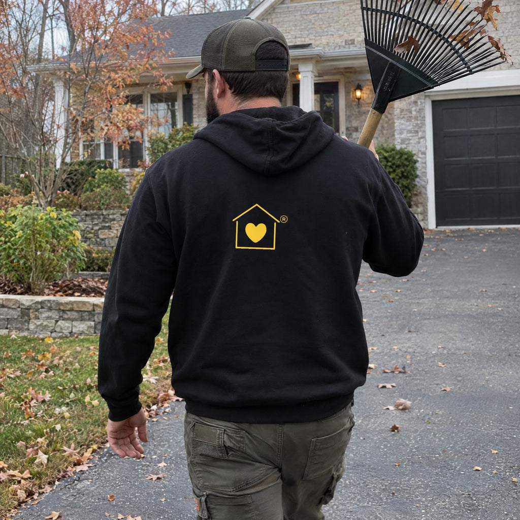 Back view of the Transcend Icon Edition black hoodie with the house-and-heart icon on the back (AI-generated example photo, logo placement matched to the real product)