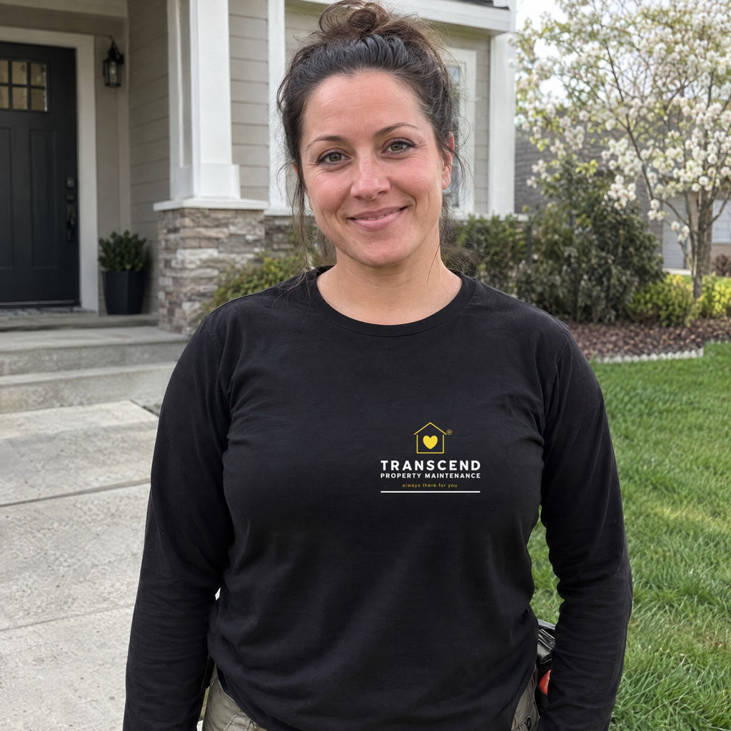 Property maintenance worker wearing the Transcend Property Maintenance black long sleeve tee with the logo on the left chest (AI-generated example photo, logo placement matched to the real product)